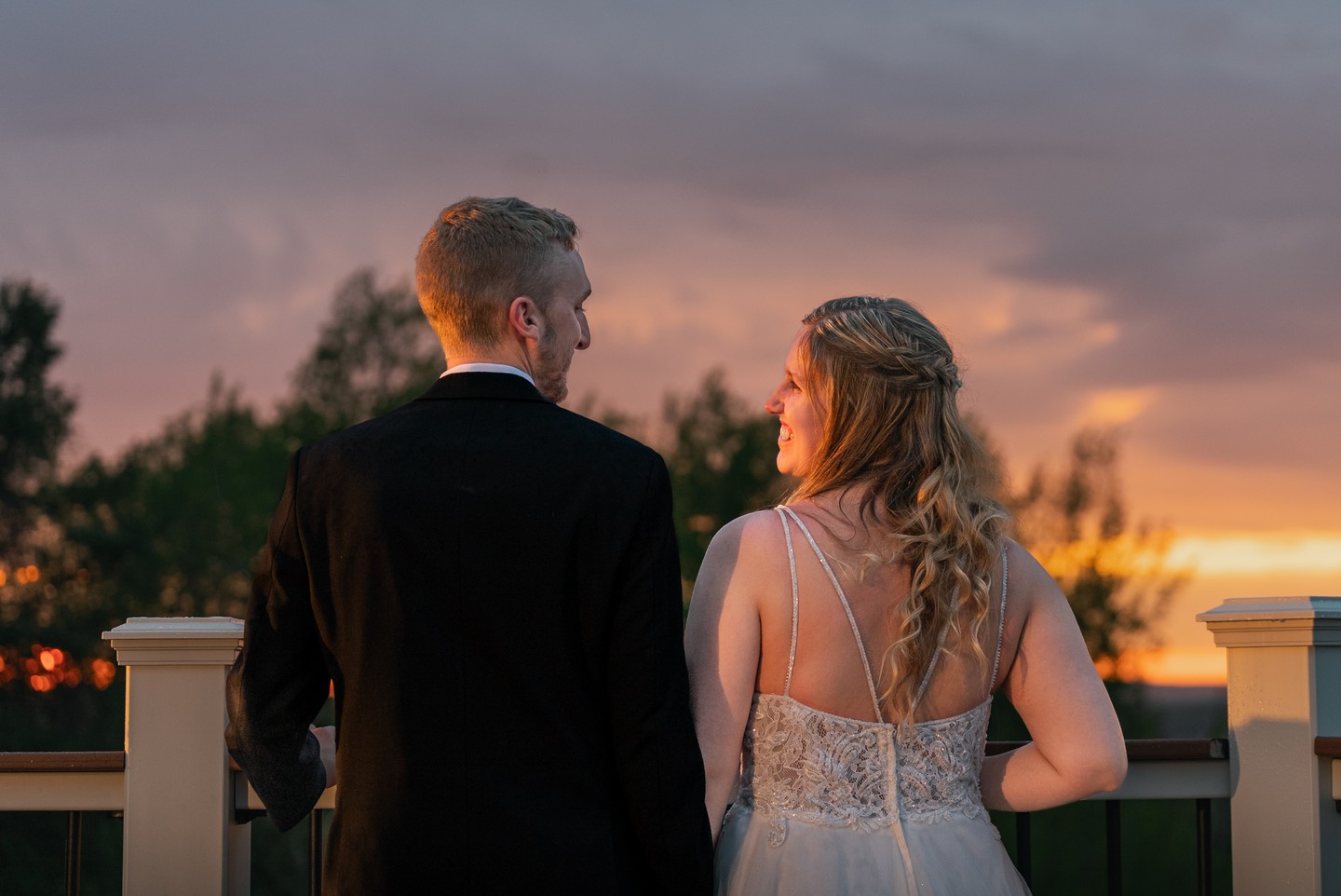 Britney and Mike on the Skyline Lodge deck at sunset, looking out over the hills.